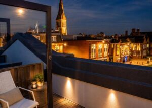Leicester city rooftops and church spire at dusk
